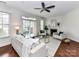 Bright living room with a fireplace, ceiling fan, and access to an outdoor patio at 8925 Rosalyn Glen Rd, Cornelius, NC 28031