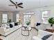 Open-concept living space with hardwood floors, a ceiling fan, and lots of natural light at 8925 Rosalyn Glen Rd, Cornelius, NC 28031