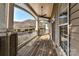 This outdoor porch has a ceiling fan, white railings, and a wooden plank floor at 8925 Rosalyn Glen Rd, Cornelius, NC 28031