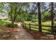 Scenic community walking trail next to a pond with a wooden fence at 8925 Rosalyn Glen Rd, Cornelius, NC 28031