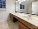 Bathroom with a double sink vanity, large mirror, and a window that provides natural lighting at 9105 Capsdale Ct, Huntersville, NC 28078