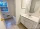 Well-lit bathroom features a vanity with modern fixtures, adding a touch of elegance at 9105 Capsdale Ct, Huntersville, NC 28078