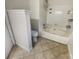 Bathroom showcases a tub and toilet. There are tile floors and built in storage at 9105 Capsdale Ct, Huntersville, NC 28078