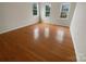 Spacious bedroom with natural light showcases hardwood flooring and neutral-colored walls at 9105 Capsdale Ct, Huntersville, NC 28078