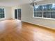 Bright dining room featuring hardwood floors, large windows, and sliding glass door to the deck at 9105 Capsdale Ct, Huntersville, NC 28078