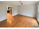 Open room featuring hardwood floors, natural light, and access to the kitchen, ideal for dining at 9105 Capsdale Ct, Huntersville, NC 28078