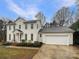 Charming two-story home features a two-car garage and manicured landscaping, enhancing curb appeal at 9105 Capsdale Ct, Huntersville, NC 28078