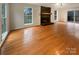 Inviting living room with a brick fireplace, hardwood floors and natural light from the big windows at 9105 Capsdale Ct, Huntersville, NC 28078