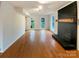 Open living room showcases hardwood floors, a charming fireplace, and natural lighting at 9105 Capsdale Ct, Huntersville, NC 28078