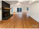 Spacious living room showcases hardwood floors and a classic brick fireplace, offering a cozy ambiance at 9105 Capsdale Ct, Huntersville, NC 28078