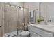 Bathroom featuring a tiled shower, modern vanity, and fixtures at 111 Old Field Rd, Statesville, NC 28677