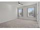 Bright bedroom features neutral paint, carpet, and two windows at 111 Old Field Rd, Statesville, NC 28677