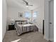 Bedroom featuring neutral tones, carpet, and natural light from two windows at 111 Old Field Rd, Statesville, NC 28677