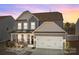 Charming two-story home with a well-maintained lawn and an attached two-car garage at 111 Old Field Rd, Statesville, NC 28677