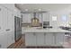 Modern kitchen with white cabinets, stainless steel appliances, and a large island at 111 Old Field Rd, Statesville, NC 28677
