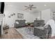 Bright living room featuring hardwood floors, modern furniture, and a stylish ceiling fan at 111 Old Field Rd, Statesville, NC 28677