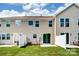 Townhome exterior with a well-maintained lawn, fence, and a patio at 12237 Gambrell Dr, Charlotte, NC 28278