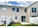 Backyard features a well-kept lawn, a patio area, and white fencing at 12237 Gambrell Dr, Charlotte, NC 28278