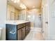 Well-lit bathroom with double vanity, tiled floors, and glass shower with tiled walls at 12237 Gambrell Dr, Charlotte, NC 28278