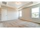 Bright bedroom with tray ceiling, carpet floors, and two windows at 12237 Gambrell Dr, Charlotte, NC 28278