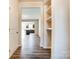 Hallway featuring wood floors and an archway looking into the kitchen and living area at 12237 Gambrell Dr, Charlotte, NC 28278