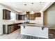 Modern kitchen with stainless steel appliances, granite countertops, a center island, and dark wood cabinetry at 12237 Gambrell Dr, Charlotte, NC 28278