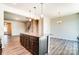Open concept kitchen with island featuring granite countertops and wood floors at 12237 Gambrell Dr, Charlotte, NC 28278