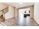 Spacious living room featuring hardwood floors, a staircase, and an open view of the modern kitchen at 12237 Gambrell Dr, Charlotte, NC 28278