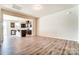 Open-concept layout with wood floors, connecting the living room and modern kitchen with an island at 12237 Gambrell Dr, Charlotte, NC 28278