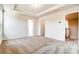 Spacious carpeted bedroom with tray ceiling and two doors at 12237 Gambrell Dr, Charlotte, NC 28278