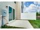 Outdoor patio area featuring a sliding glass door, vinyl siding, and a white privacy fence at 12237 Gambrell Dr, Charlotte, NC 28278