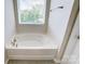 This bathroom boasts a garden tub with a large window at 12241 Gambrell Dr, Charlotte, NC 28278