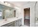 A bathroom with double vanity, walk in shower, and walk in closet at 12241 Gambrell Dr, Charlotte, NC 28278