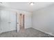This bedroom features neutral carpet, a double door closet and a door to the bathroom at 12241 Gambrell Dr, Charlotte, NC 28278
