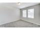This bedroom features neutral carpet and two windows at 12241 Gambrell Dr, Charlotte, NC 28278