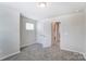 This bedroom features neutral carpet and a double door closet at 12241 Gambrell Dr, Charlotte, NC 28278