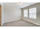 This bedroom features neutral carpet and two windows at 12241 Gambrell Dr, Charlotte, NC 28278