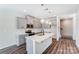 A modern kitchen boasts stainless steel appliances, gray wooden cabinets, and an island with a sink at 12241 Gambrell Dr, Charlotte, NC 28278