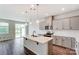 A modern kitchen boasts stainless steel appliances, pendant lighting, and an island with a sink at 12241 Gambrell Dr, Charlotte, NC 28278