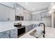 A detailed view of the kitchen reveals stainless steel appliances, gray wooden cabinets, and white backsplash at 12241 Gambrell Dr, Charlotte, NC 28278