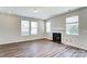 Spacious living room features a fireplace, large windows, and hardwood floors for a bright atmosphere at 12241 Gambrell Dr, Charlotte, NC 28278