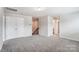 Neutral upstairs hallway featuring carpet, railing, closet, and a ceiling light at 12241 Gambrell Dr, Charlotte, NC 28278