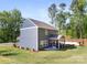 Home exterior with a screened-in porch surrounded by a manicured lawn and mature trees at 1402 Richmond Dr # 1, Lowell, NC 28098