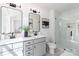 Modern bathroom with dual vanities, sleek fixtures, and a glass-enclosed shower at 1402 Richmond Dr # 1, Lowell, NC 28098