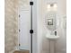 Elegant powder room featuring stylish wallpaper and a pedestal sink at 1402 Richmond Dr # 1, Lowell, NC 28098