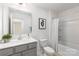 Neutral colored bathroom with tub and shower combo and ample lighting at 1402 Richmond Dr # 1, Lowell, NC 28098