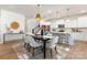 Inviting dining space with hardwood floors and a view to the kitchen with pendant lighting and staircase at 1402 Richmond Dr # 1, Lowell, NC 28098
