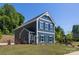 Charming two-story new construction home featuring navy siding, white trim, and a well-manicured front lawn at 1402 Richmond Dr # 1, Lowell, NC 28098
