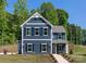 Attractive new construction home with navy siding, white trim, shutters, and a welcoming walkway at 1402 Richmond Dr # 1, Lowell, NC 28098