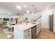 Stylish kitchen with stainless steel appliances, island with seating, and an open view to the dining and living areas at 1402 Richmond Dr # 1, Lowell, NC 28098